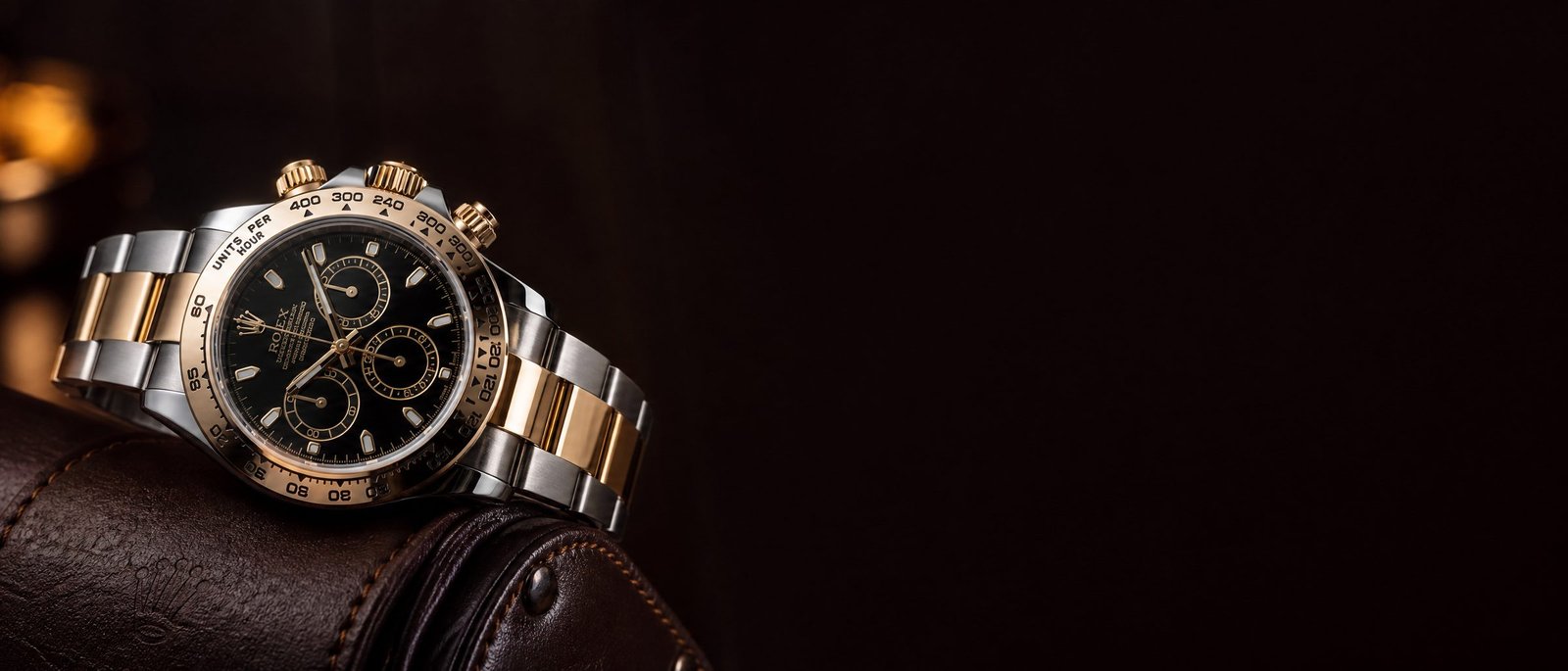 Luxury two-tone chronograph resting on dark leather